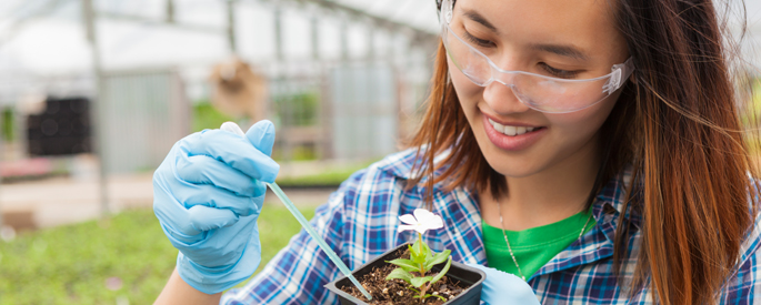 student studying botany in greenhouse