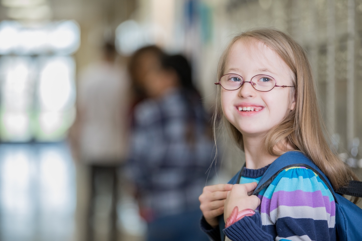 Smiling elementary girl with down syndrome