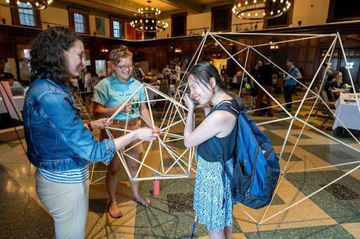 Conference Organizer Emily Nott, Building with Attendees in the PML 2023 Arcade Space (Photo credit: Andy Manis)