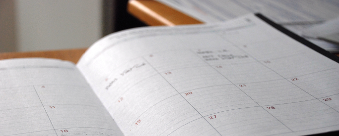 Image of a calendar open on a desk
