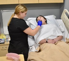 Student nurse taking temperature