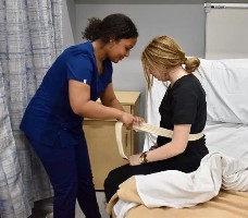 Student nurse transferring a patient