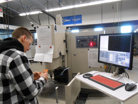 Youth apprentice sets up machine tool job