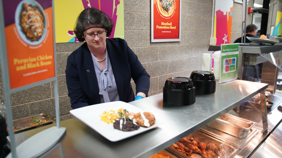 Dr. Jill Underly, State Superintendent for Public Instruction, serves meals in the lunch line at Glendale School of the Arts in Racine, WI
