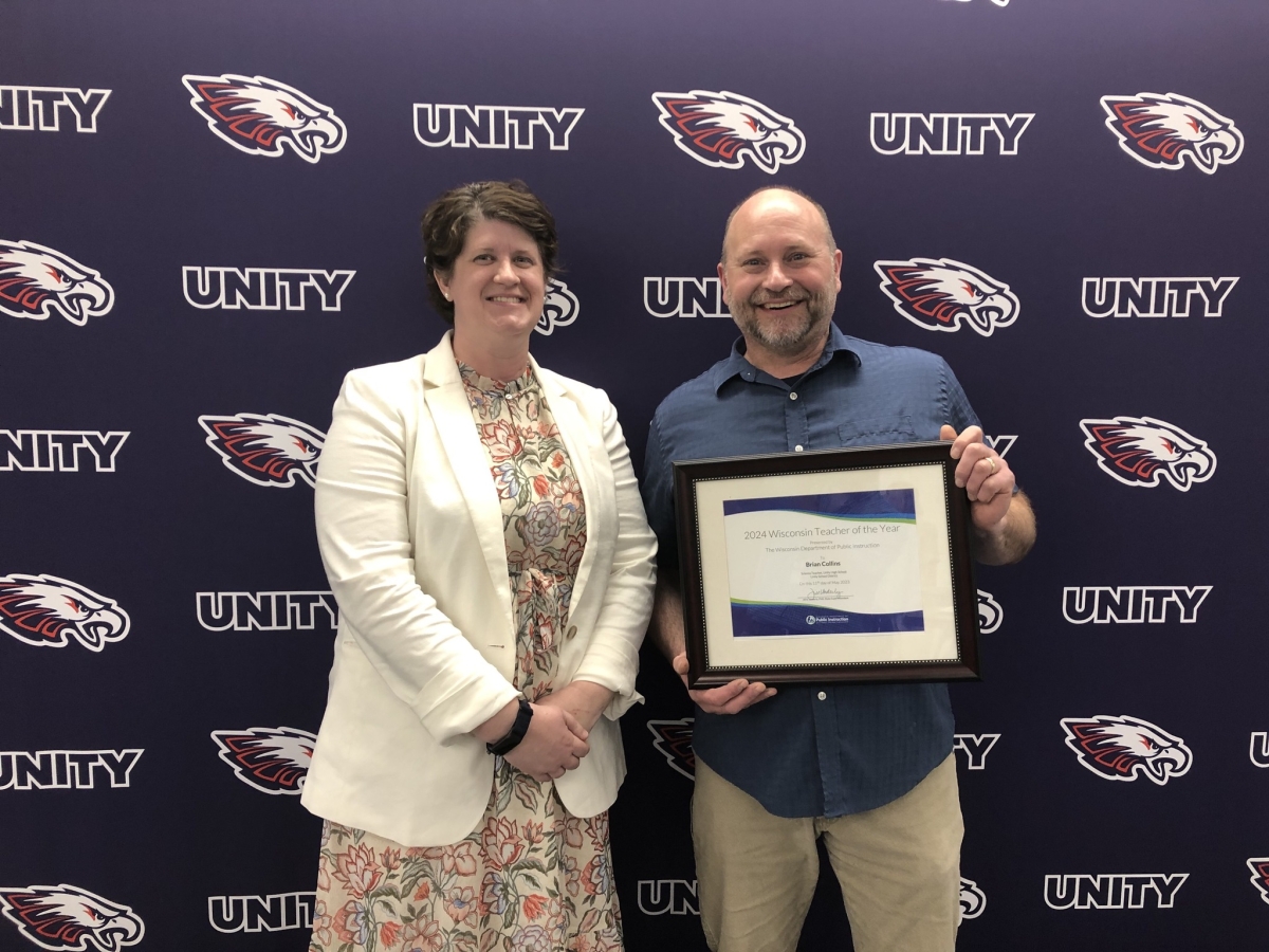 Dr. Jill Underly, State Superintendent of Public Instruction, presents Brian Collins with his Wisconsin Teacher of the Year 2024 award in May of 2023