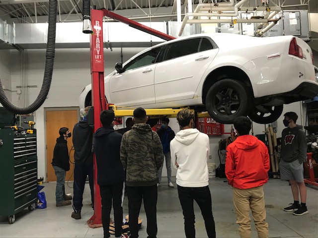 students working with car