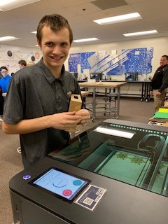 Student, Riley Sontag with laser cutter