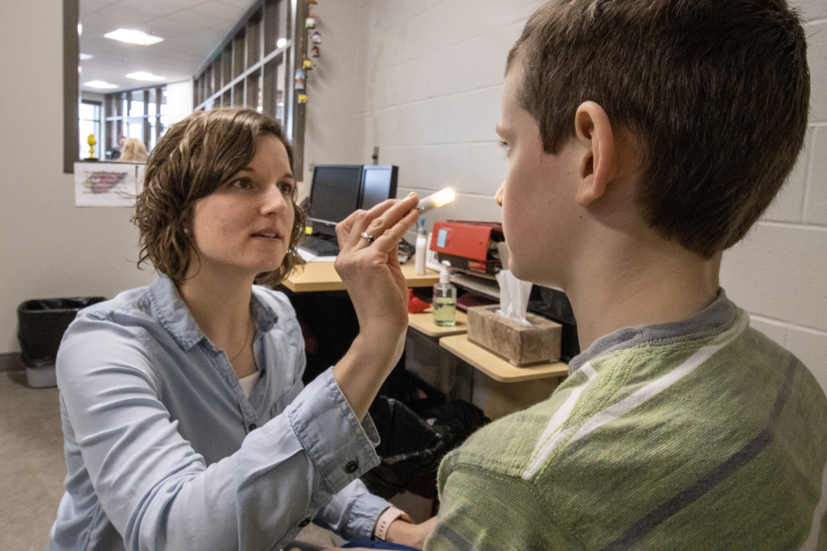 Wisconsin school nurse examines a student