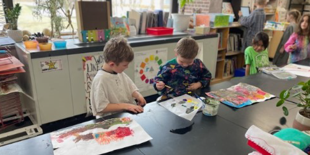 Kids together painting at a table
