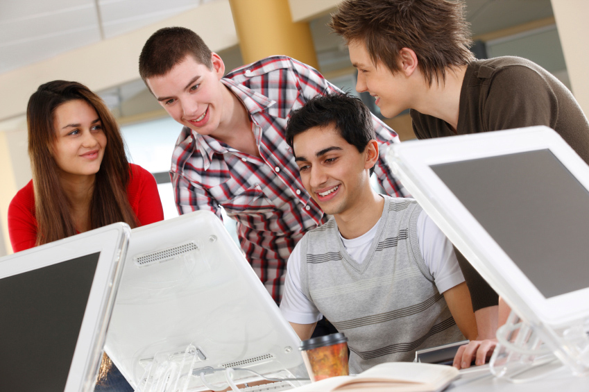 group of high school students with laptops