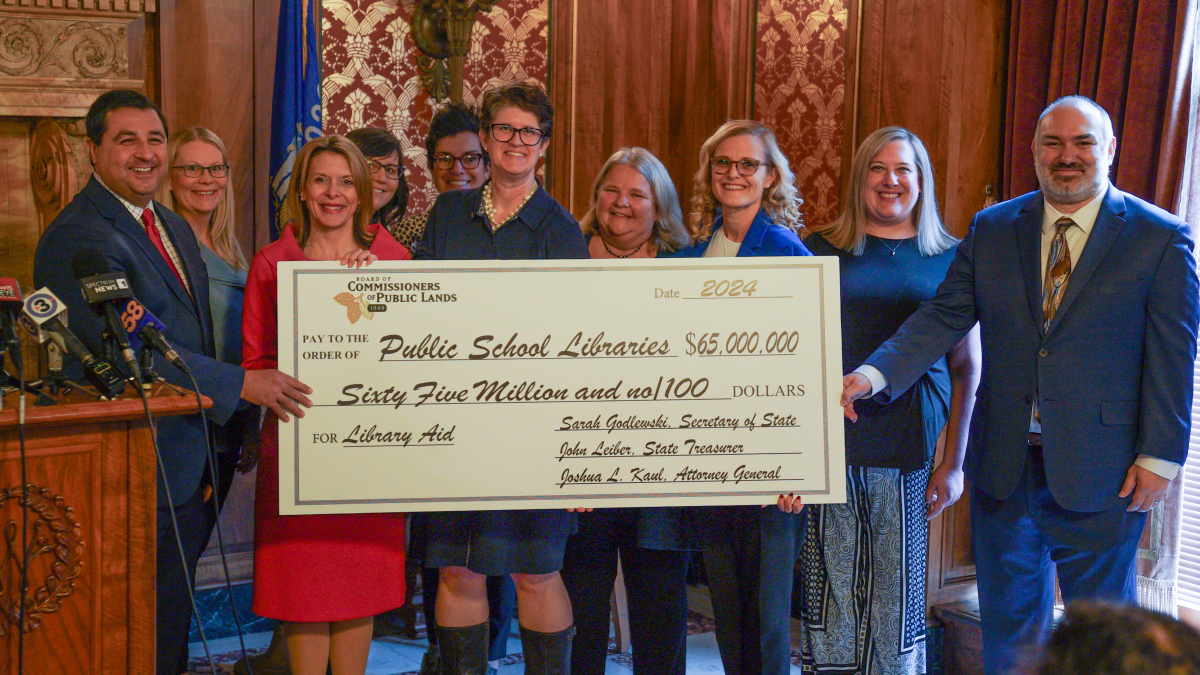 State Superintendent of Public Education Dr. Jill Underly holds an oversized check representing the $65 million allocated from the General School Fund for School Library Aid for the 2023-24 school year.