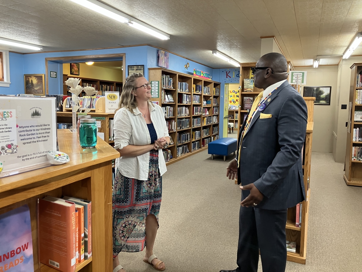Dr. Williams and Greenwood Library Director talking in library