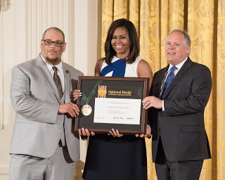 Rob Franklin and Library Director Greg Mickells  accept a 2016 National Medal for Library Service  awarded by First Lady Michelle Obama at The White House