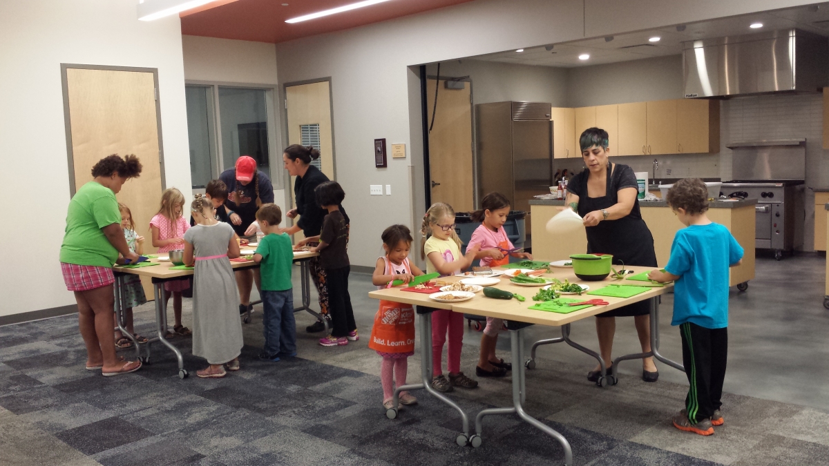Kids participate in a cooking class featuring fresh fruits  and vegetables at Meadowridge Library