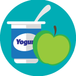 Container of yogurt with a spoon in it next to a green apple